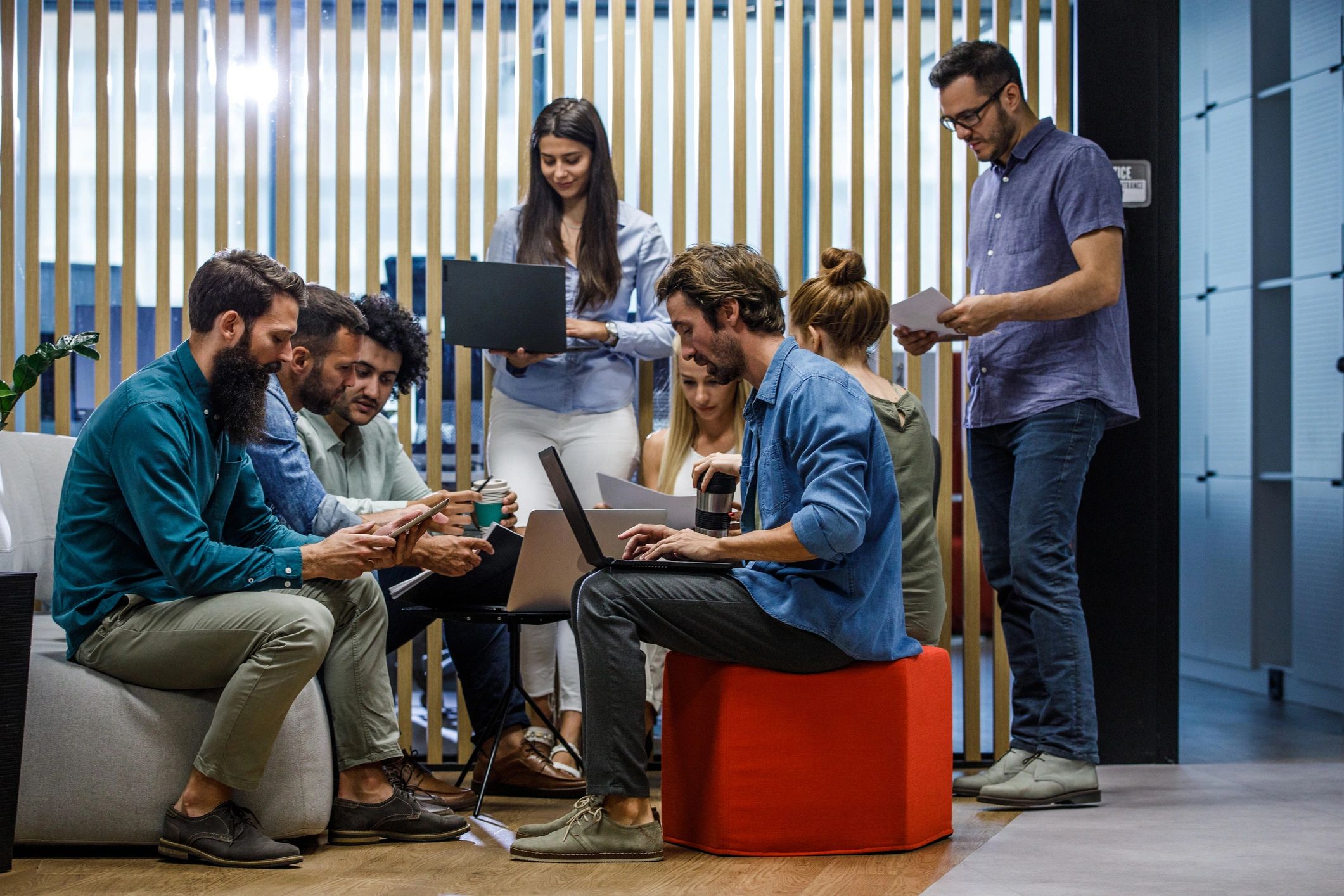 Creative agency team collaborating in a modern office lounge